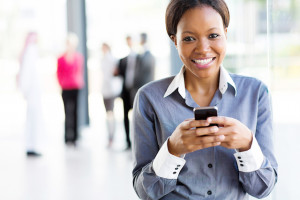 african businesswoman using smart phone in modern office