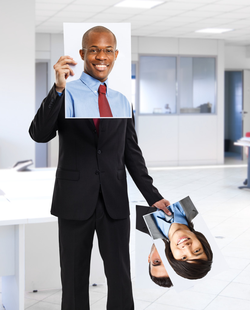 Man holding portraits of other people