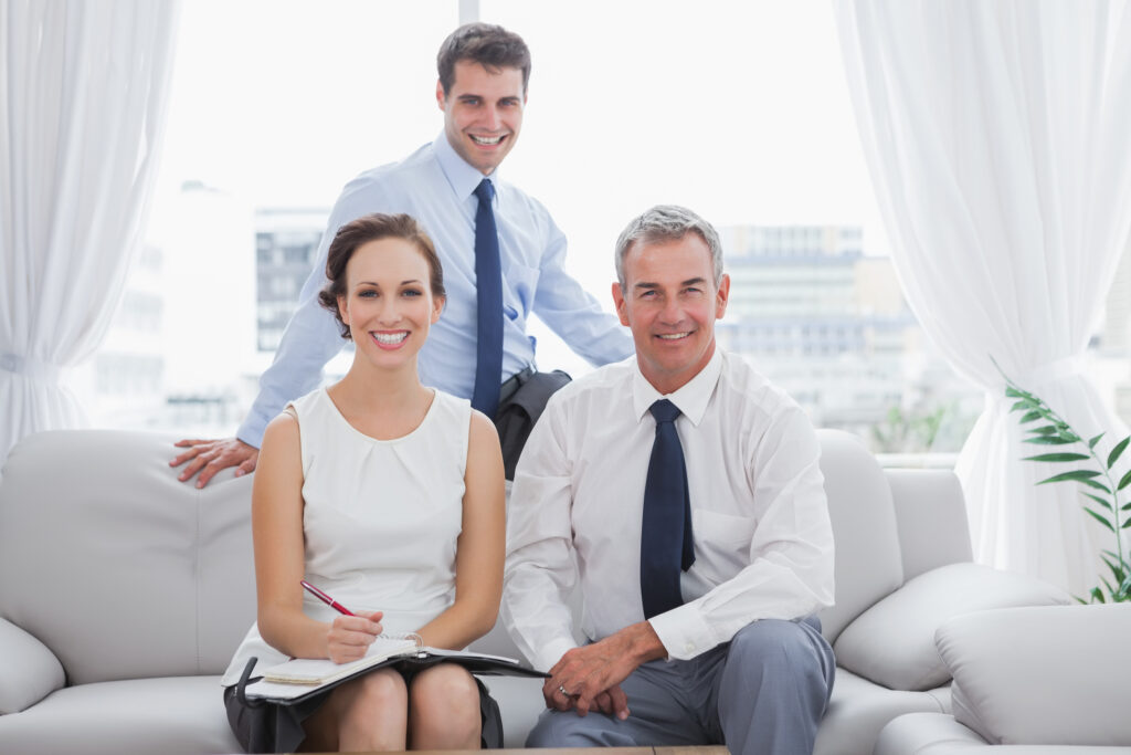 Cheerful partners posing while having a meeting in cosy meeting