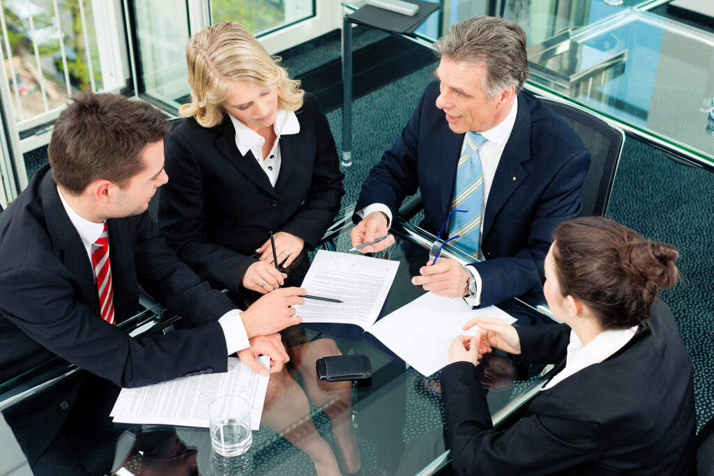 Business - meeting in an office; the businesspeople are discussing a document